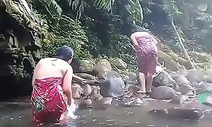 Comely girls having bath open-air